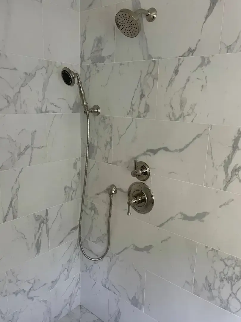 Modern shower with marble tile and chrome fixtures